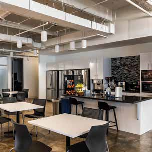 a large open office with tables and chairs